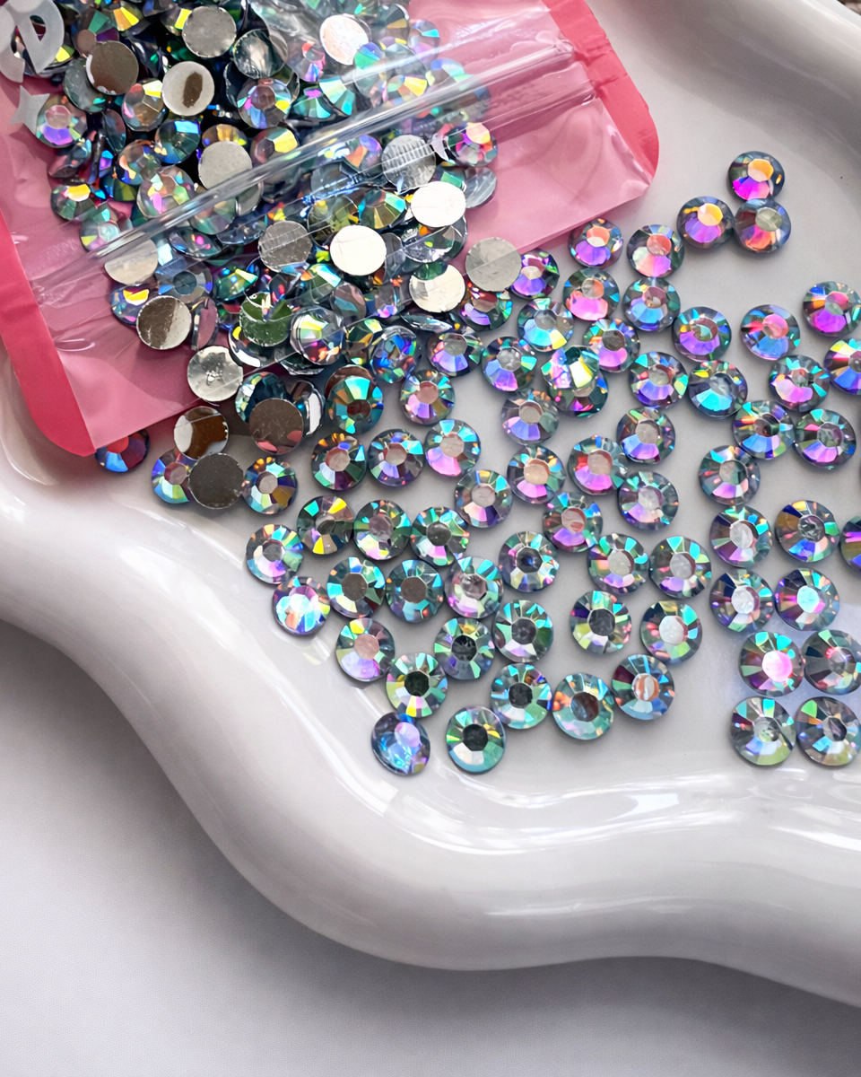 Multicolored rhinestones on a white tray with pink packaging