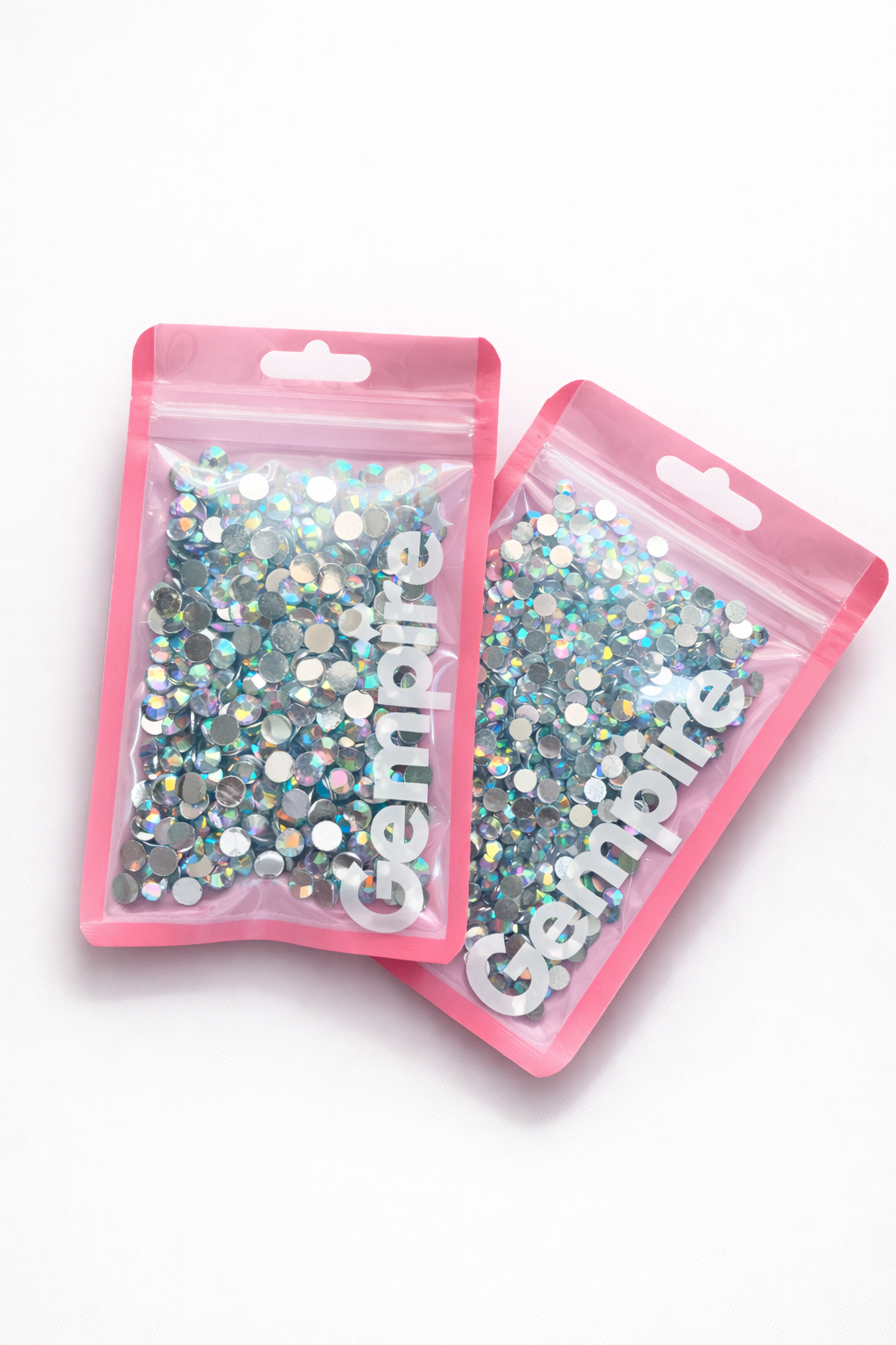 Two pink packages of gemfire crystals on a white background